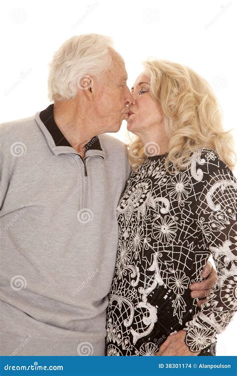 old man kissing|Passionate mature couple making out near .